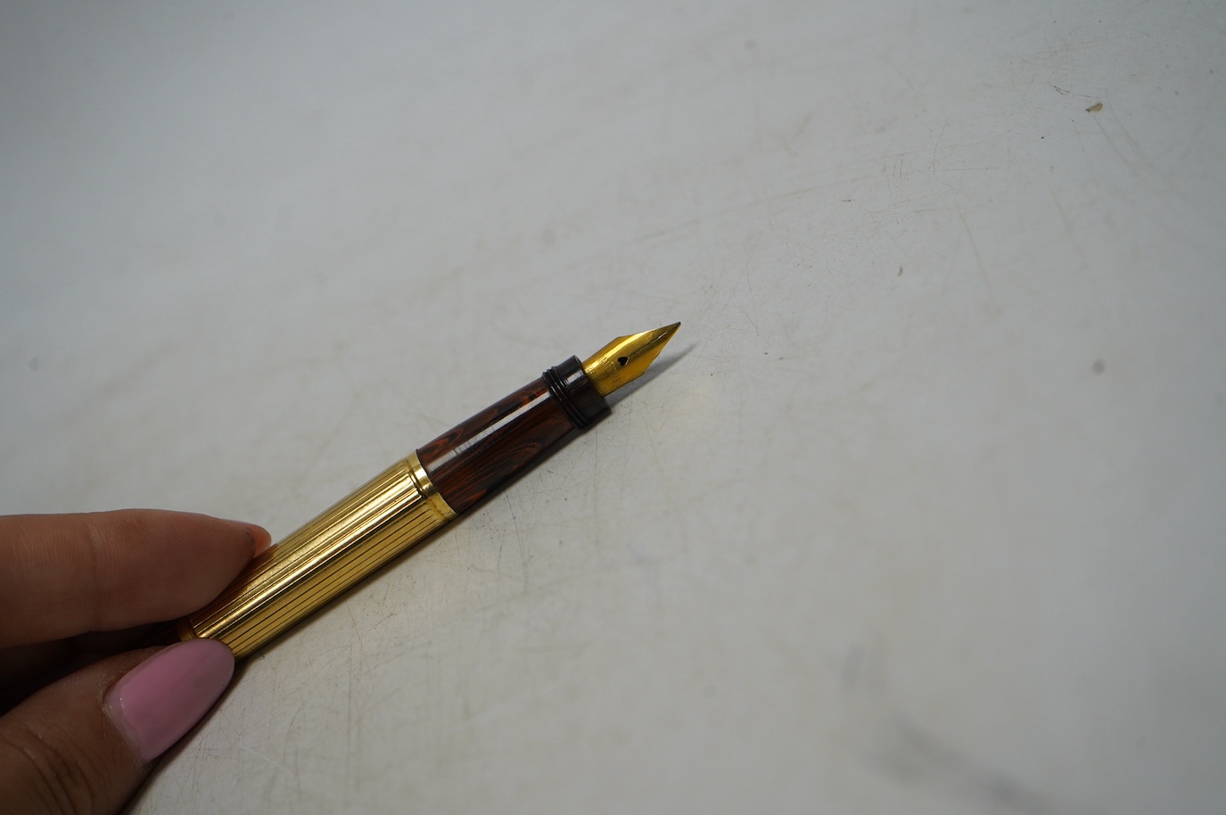 A Watermans Ideal red ripple hard rubber safety pen with Orix gold plated overlay. Condition - good, red a little faded